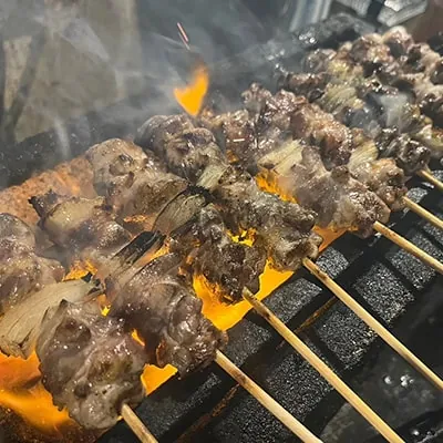 炭火で焼かれる焼き鳥の串